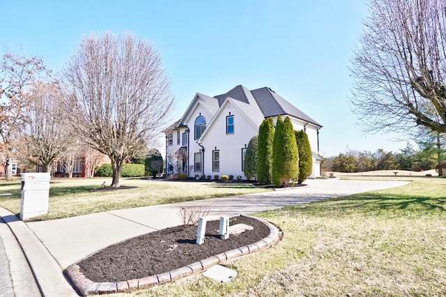 view of side of home with a lawn and stucco siding