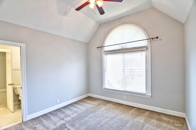 unfurnished room featuring vaulted ceiling, carpet floors, ceiling fan, and baseboards