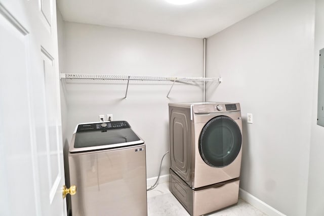 washroom featuring laundry area, baseboards, marble finish floor, and washer and dryer