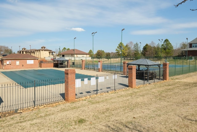 pool featuring fence and a gazebo