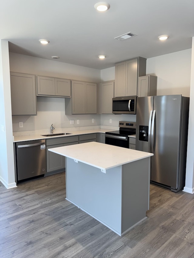 kitchen with gray cabinets, light countertops, visible vents, appliances with stainless steel finishes, and a sink