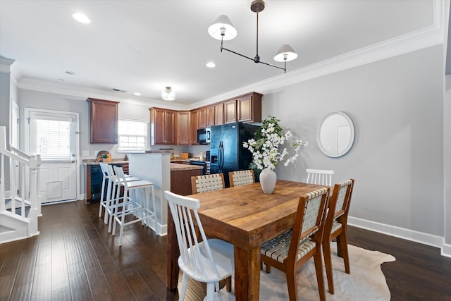 dining room with ornamental molding, recessed lighting, dark wood finished floors, and baseboards