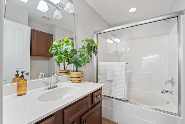 full bathroom featuring combined bath / shower with glass door, vanity, visible vents, and recessed lighting