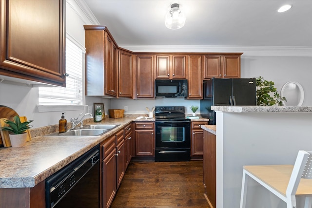 kitchen featuring crown molding, light countertops, a sink, and black appliances