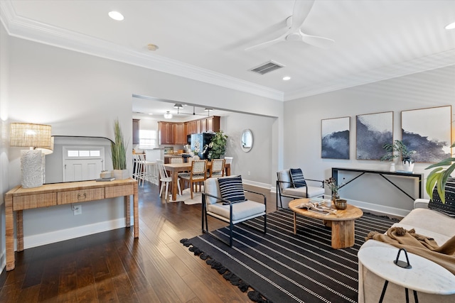 living area with baseboards, visible vents, wood-type flooring, crown molding, and recessed lighting