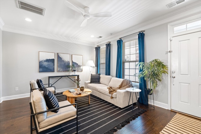 living area with visible vents, dark wood-type flooring, and ornamental molding