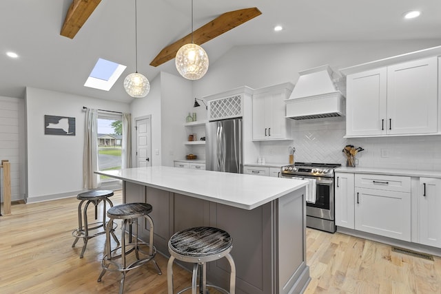 kitchen with open shelves, stainless steel appliances, light countertops, custom range hood, and white cabinets