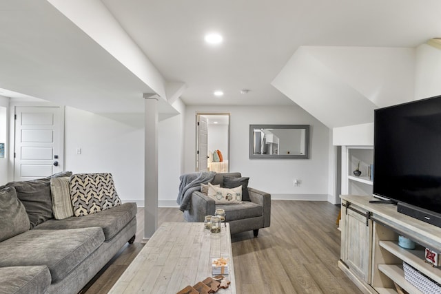 living room featuring baseboards, wood finished floors, and recessed lighting