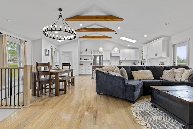 living area featuring plenty of natural light, light wood-style flooring, high vaulted ceiling, and beamed ceiling