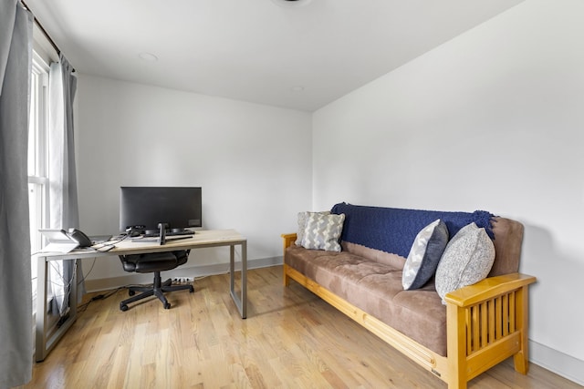 home office featuring light wood-type flooring and baseboards