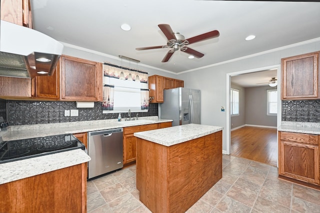 kitchen featuring a center island, brown cabinets, crown molding, stainless steel appliances, and decorative backsplash