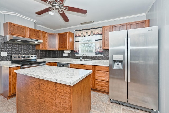 kitchen with under cabinet range hood, a sink, light countertops, appliances with stainless steel finishes, and a center island