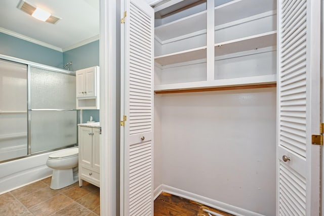 full bath with bath / shower combo with glass door, a closet, visible vents, and crown molding