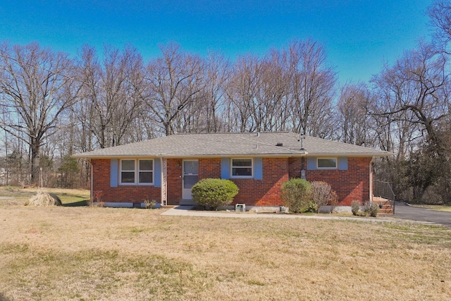 ranch-style house featuring a front yard and brick siding