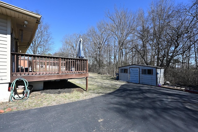 view of yard with an outbuilding and a wooden deck