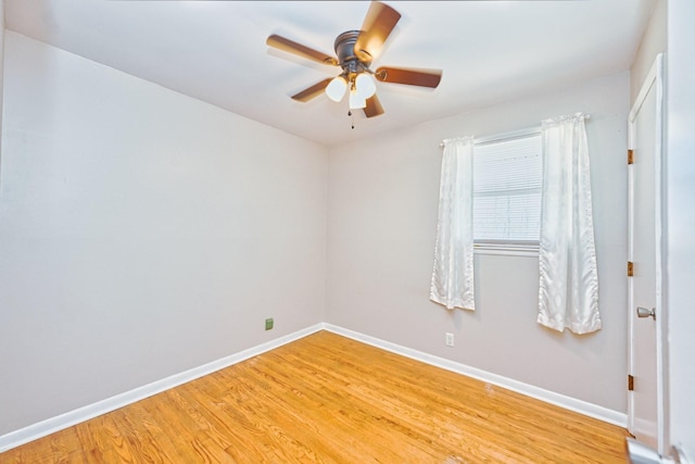 unfurnished room featuring ceiling fan, baseboards, and wood finished floors