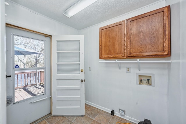 laundry room with cabinet space, baseboards, washer hookup, and a textured ceiling