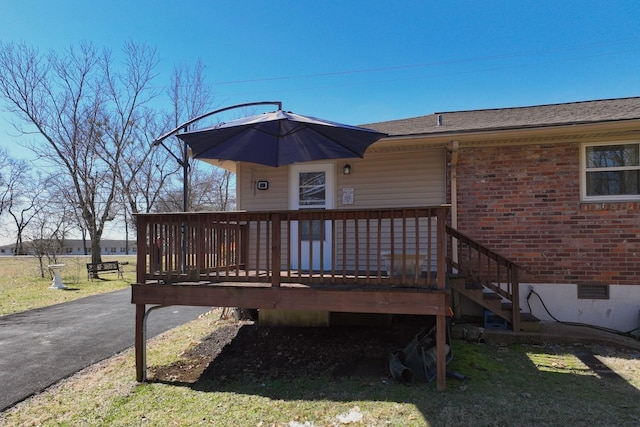 exterior space with driveway and a lawn