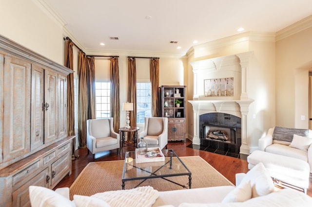 living room with crown molding, a fireplace, dark wood-style flooring, and recessed lighting