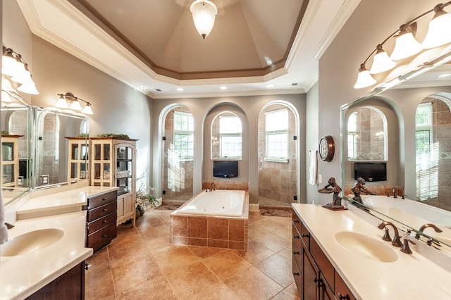 bathroom with a walk in shower, two vanities, a sink, ornamental molding, and a bath