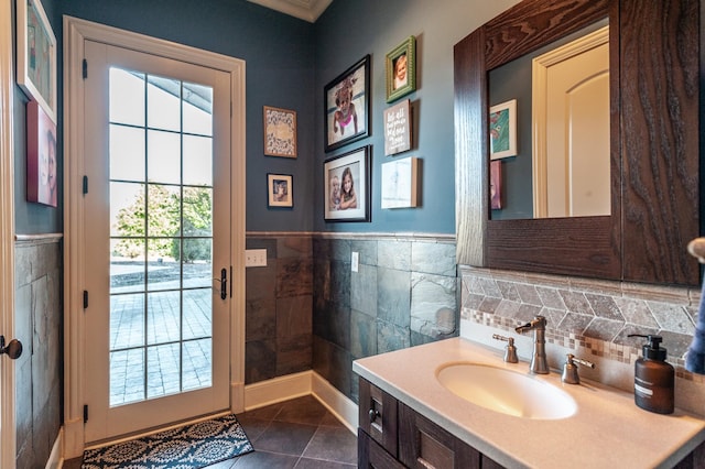 bathroom featuring a wainscoted wall, vanity, tile walls, and tile patterned floors