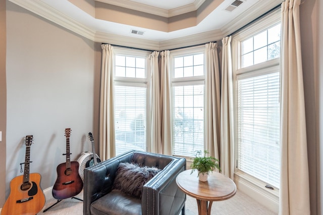 living area featuring ornamental molding, a raised ceiling, and visible vents