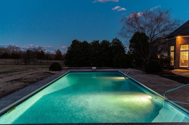 outdoor pool with a patio area and fence