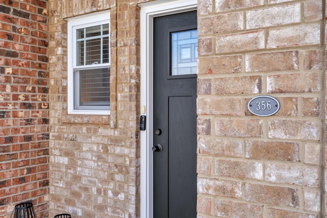 entrance to property with brick siding