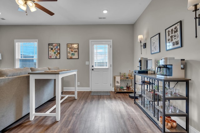 entryway featuring baseboards, plenty of natural light, visible vents, and wood finished floors