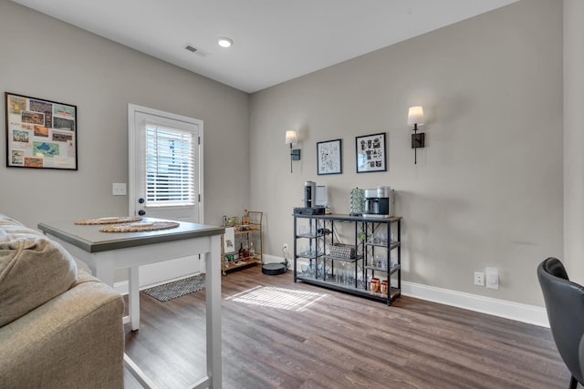 office with visible vents, baseboards, and wood finished floors