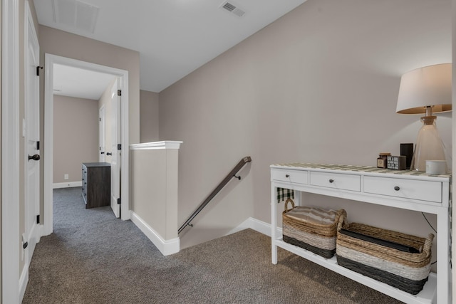 hallway with carpet, baseboards, visible vents, and an upstairs landing