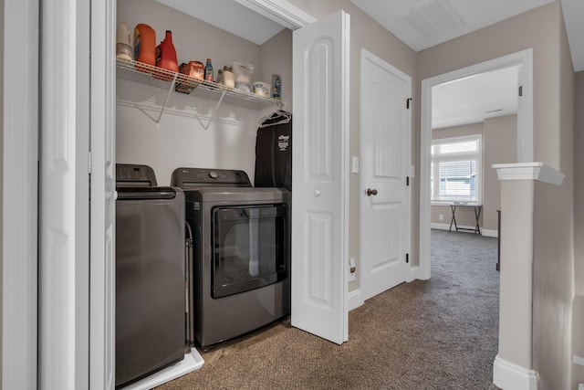 washroom with laundry area, visible vents, baseboards, washer and clothes dryer, and carpet