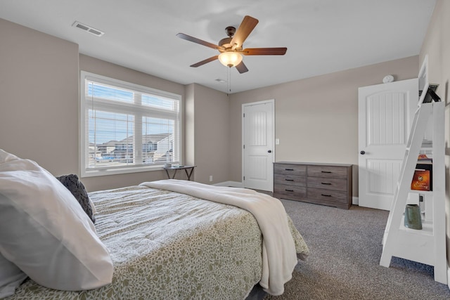 carpeted bedroom featuring visible vents and ceiling fan