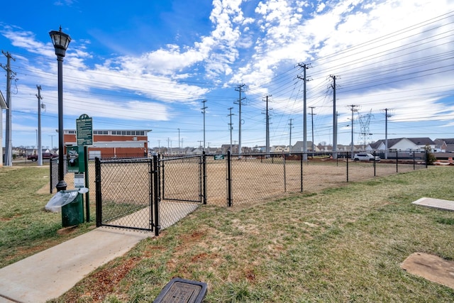 surrounding community featuring a gate, a yard, and fence