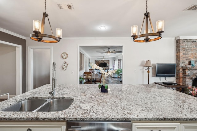 kitchen featuring open floor plan, white cabinetry, a sink, and visible vents