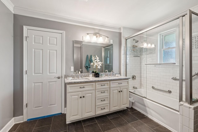 full bathroom featuring combined bath / shower with glass door, a sink, and crown molding