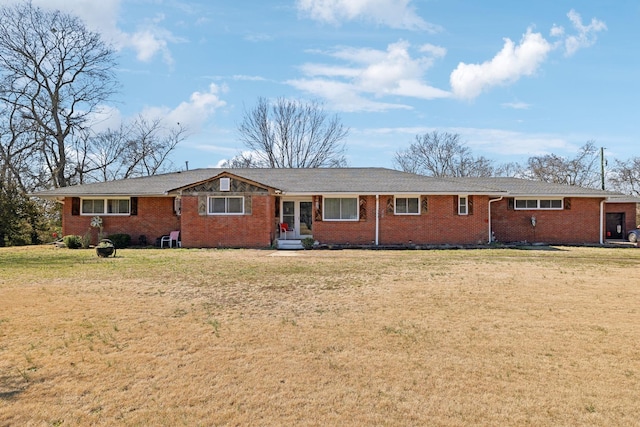 single story home featuring brick siding and a front yard