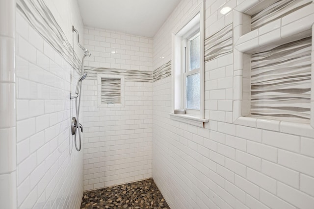 full bathroom with a tile shower