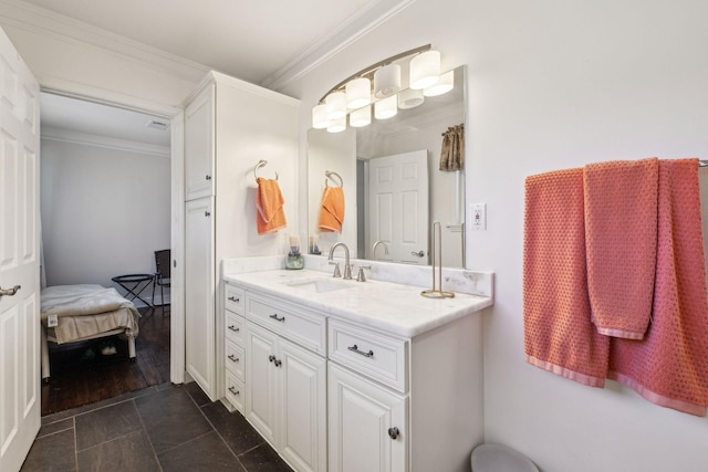 ensuite bathroom featuring crown molding, connected bathroom, and vanity