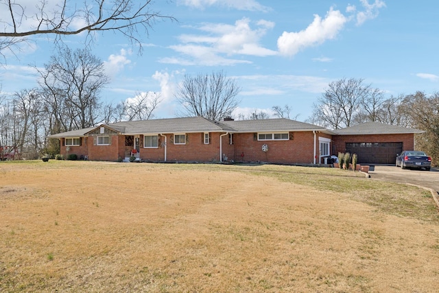 ranch-style home with a front yard, brick siding, driveway, and an attached garage