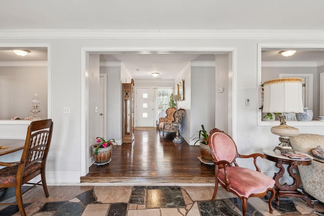 foyer with dark wood-type flooring, crown molding, and baseboards