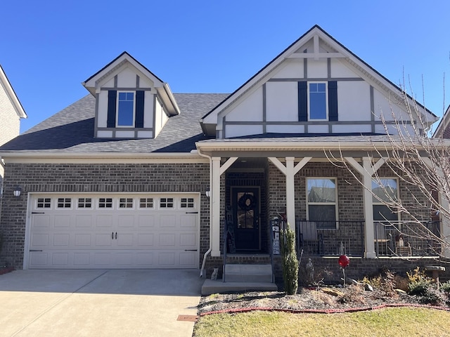 view of front of home with brick siding, roof with shingles, covered porch, an attached garage, and driveway