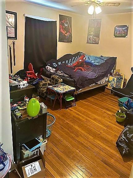 bedroom featuring a ceiling fan and wood finished floors