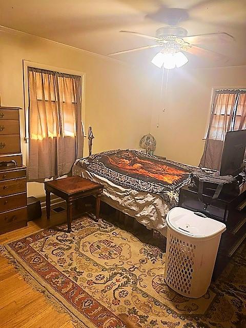 bedroom featuring ceiling fan and wood finished floors