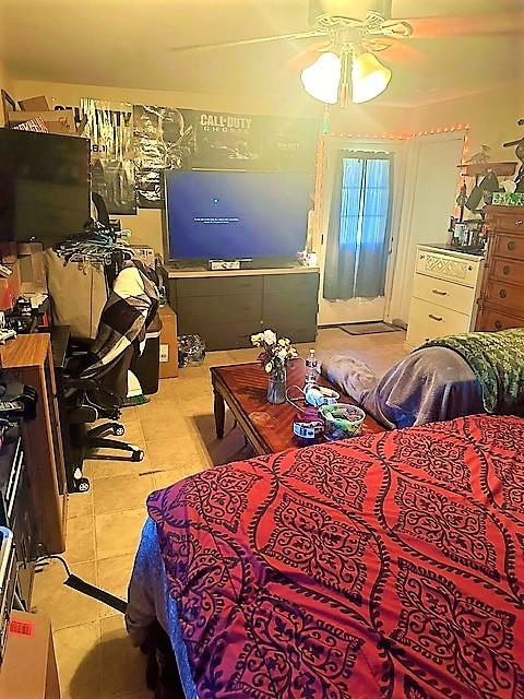 bedroom with light tile patterned floors and ceiling fan