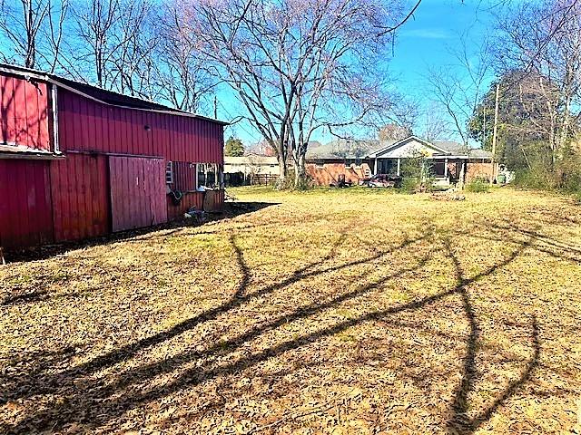 view of yard featuring a barn and an outdoor structure