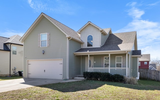 traditional-style house with an attached garage, covered porch, a shingled roof, driveway, and a front yard