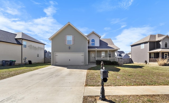 traditional-style home with an attached garage, fence, concrete driveway, and a front yard