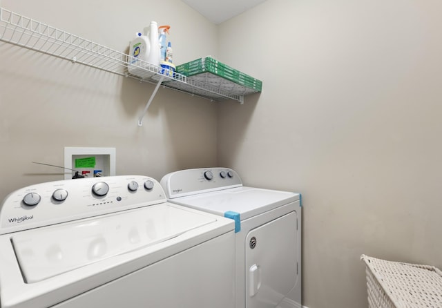 clothes washing area featuring laundry area and separate washer and dryer