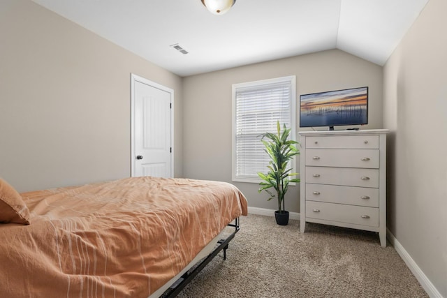 bedroom with baseboards, visible vents, vaulted ceiling, and light colored carpet